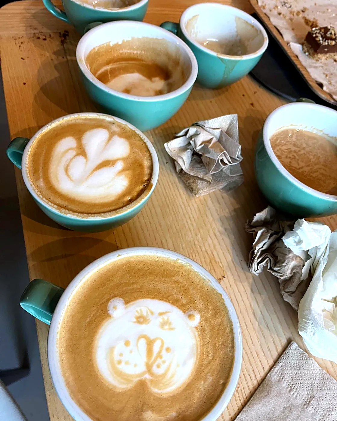 Latte art bear and rosettas on the bar
